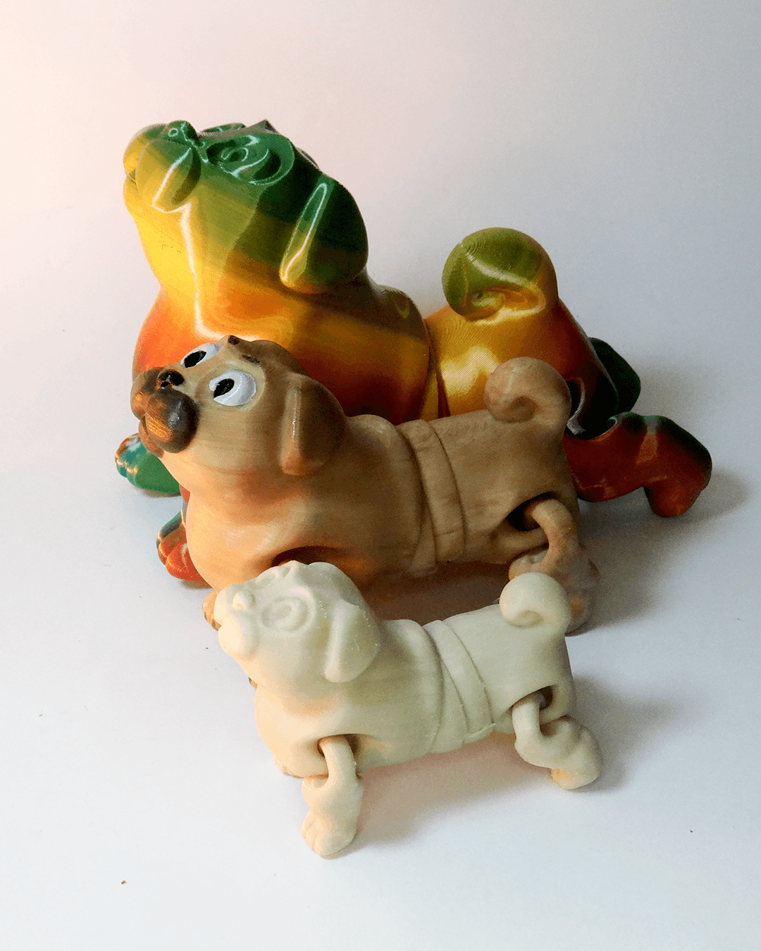 Heady Prints 3D printed tan pug figurine, small to big, view