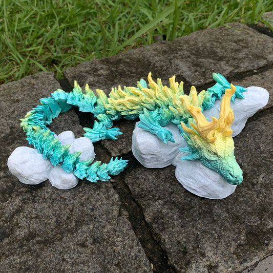 Heady Prints 3D printed Zandhros teal and yellow dragon figurine held in hand, scale reference