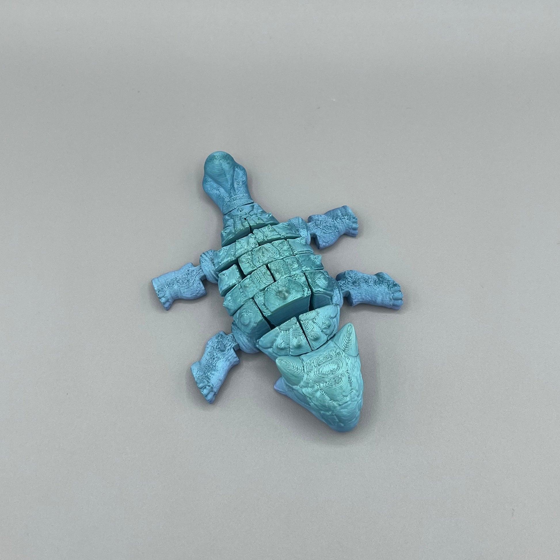 Heady Prints 3D printed blue articulated ankylosaurus, side view