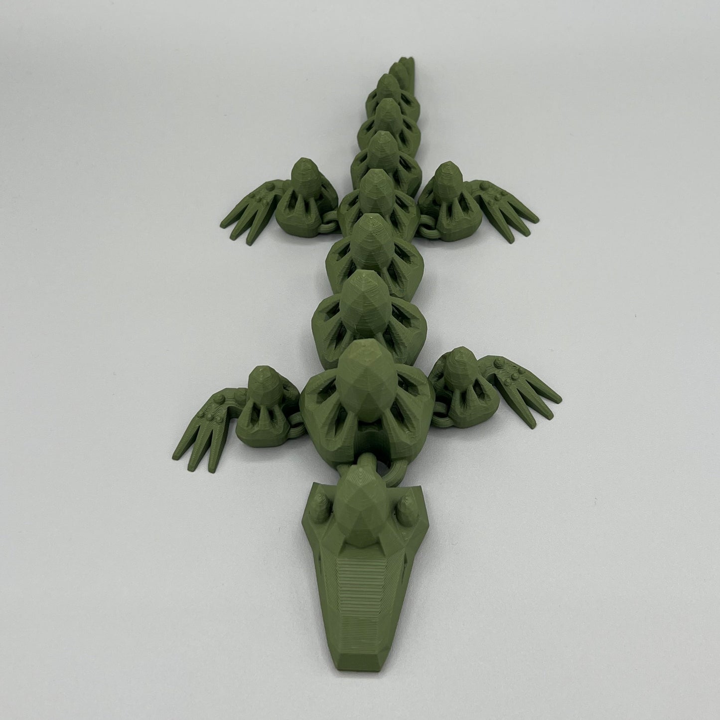 Heady Prints 3D printed green articulated gem lizard, side view