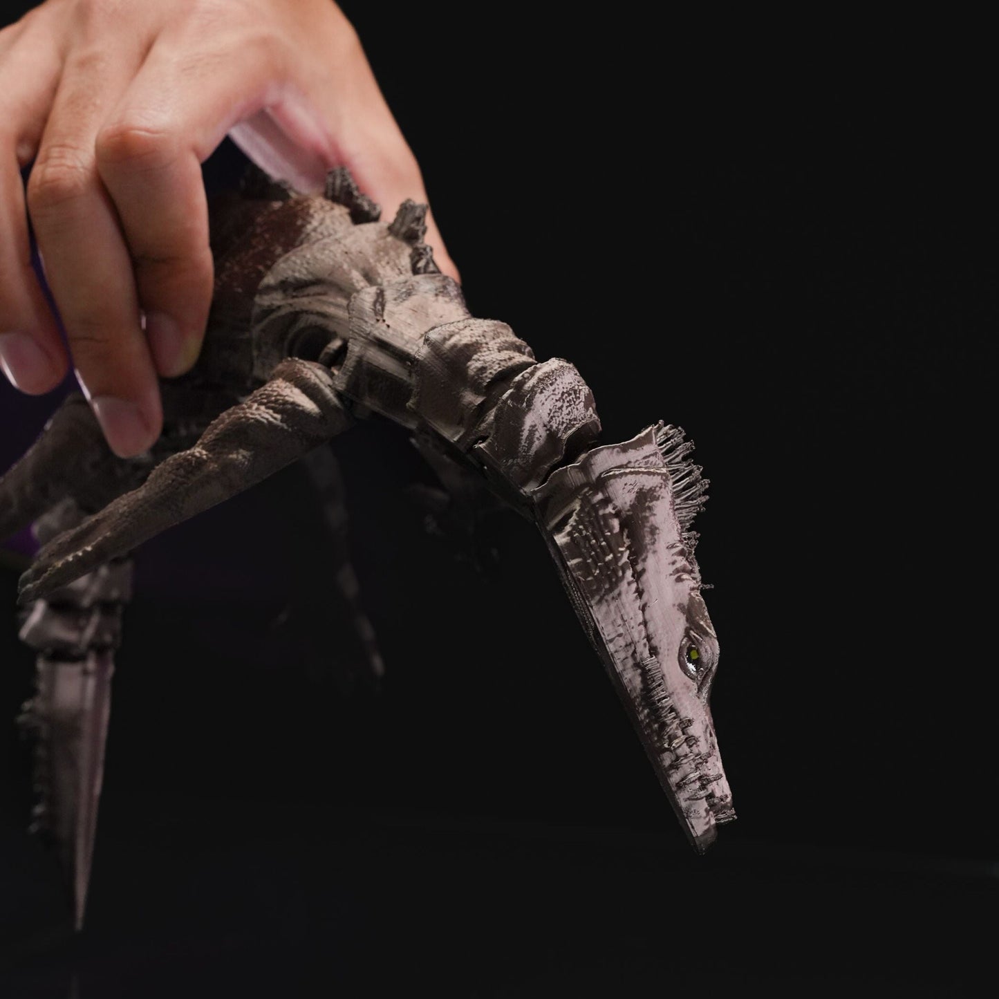 Heady Prints 3D printed articulated nothosaurus figurine held in hand, scale reference