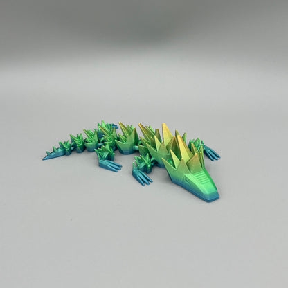 Heady Prints 3D printed green and yellow articulated spikey lizard, side view