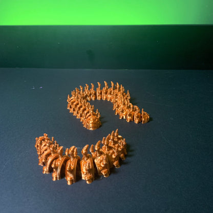Heady Prints 3D printed orange Boterpillar figurine coiled, desk companion collectible