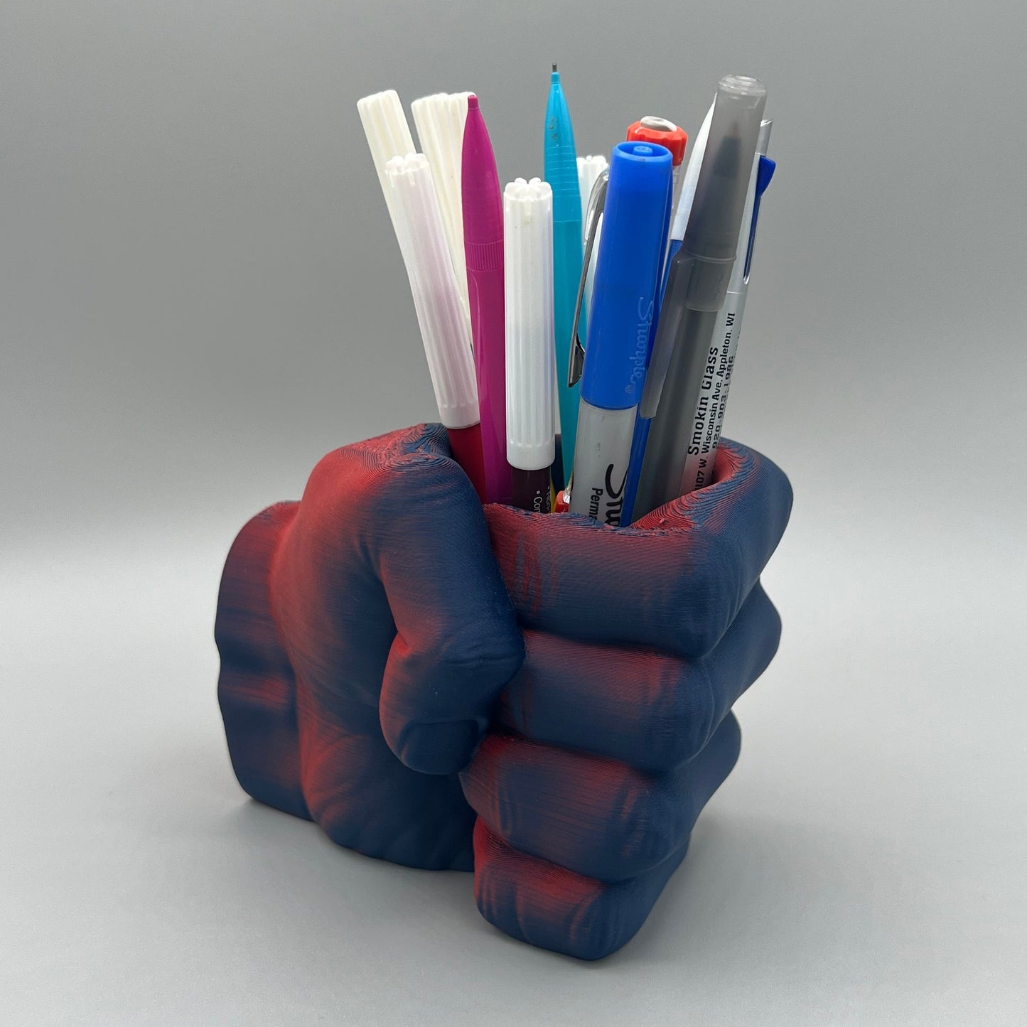 Heady Prints 3D printed red and blue fist pencil holder, three quarter view