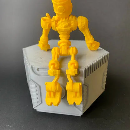 Heady Prints 3D printed yellow junkyard robot, three quarter view