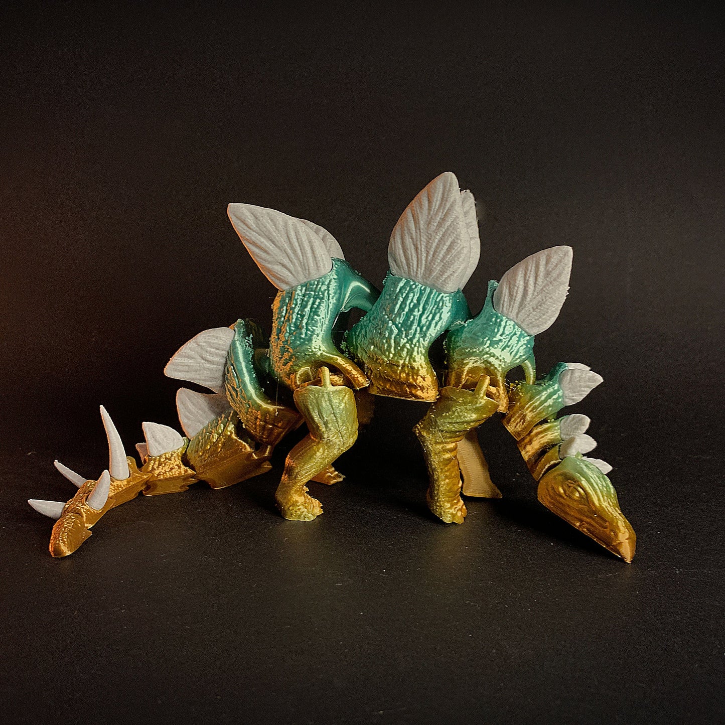 Heady Prints 3D printed teal stegosaurus figurine lifestyle shot, desk companion