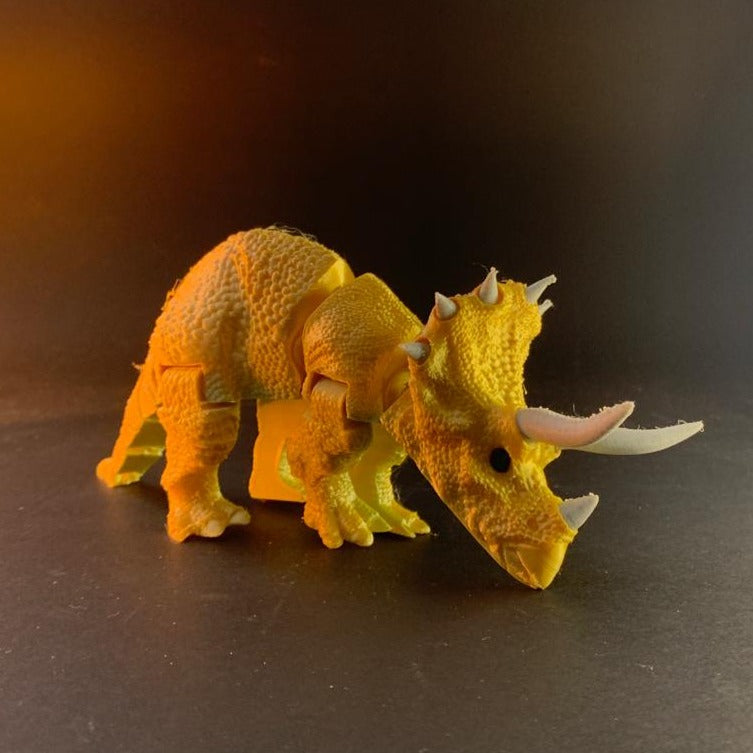 Heady Prints 3D printed orange articulated triceratops figurine, angled view
