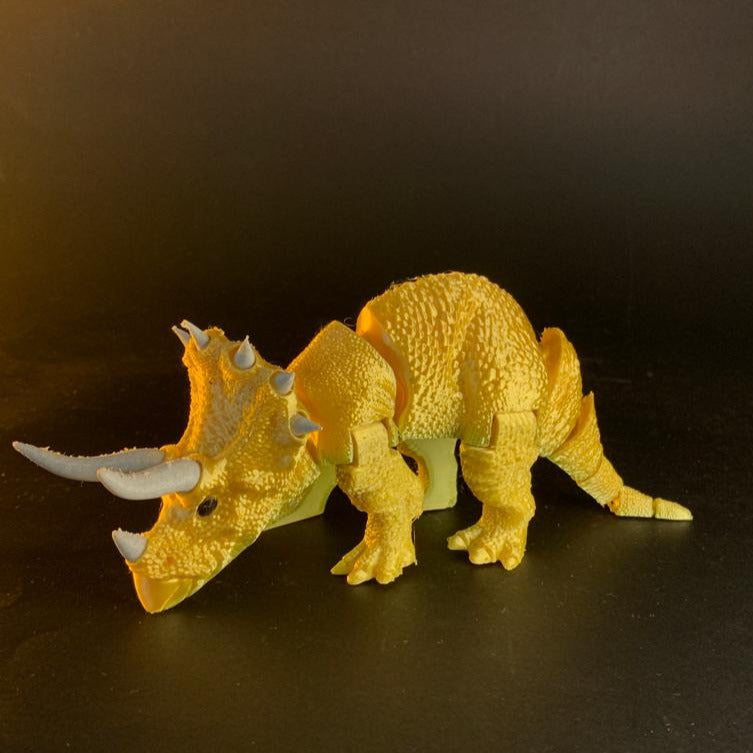 Heady Prints 3D printed orange articulated triceratops figurine, front view