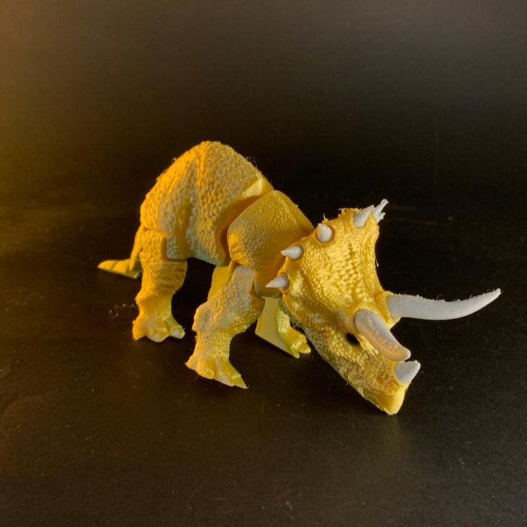 Heady Prints 3D printed orange articulated triceratops figurine, side view