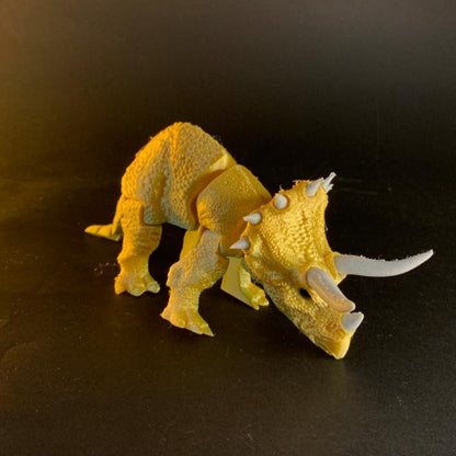 Heady Prints 3D printed orange articulated triceratops figurine, side view