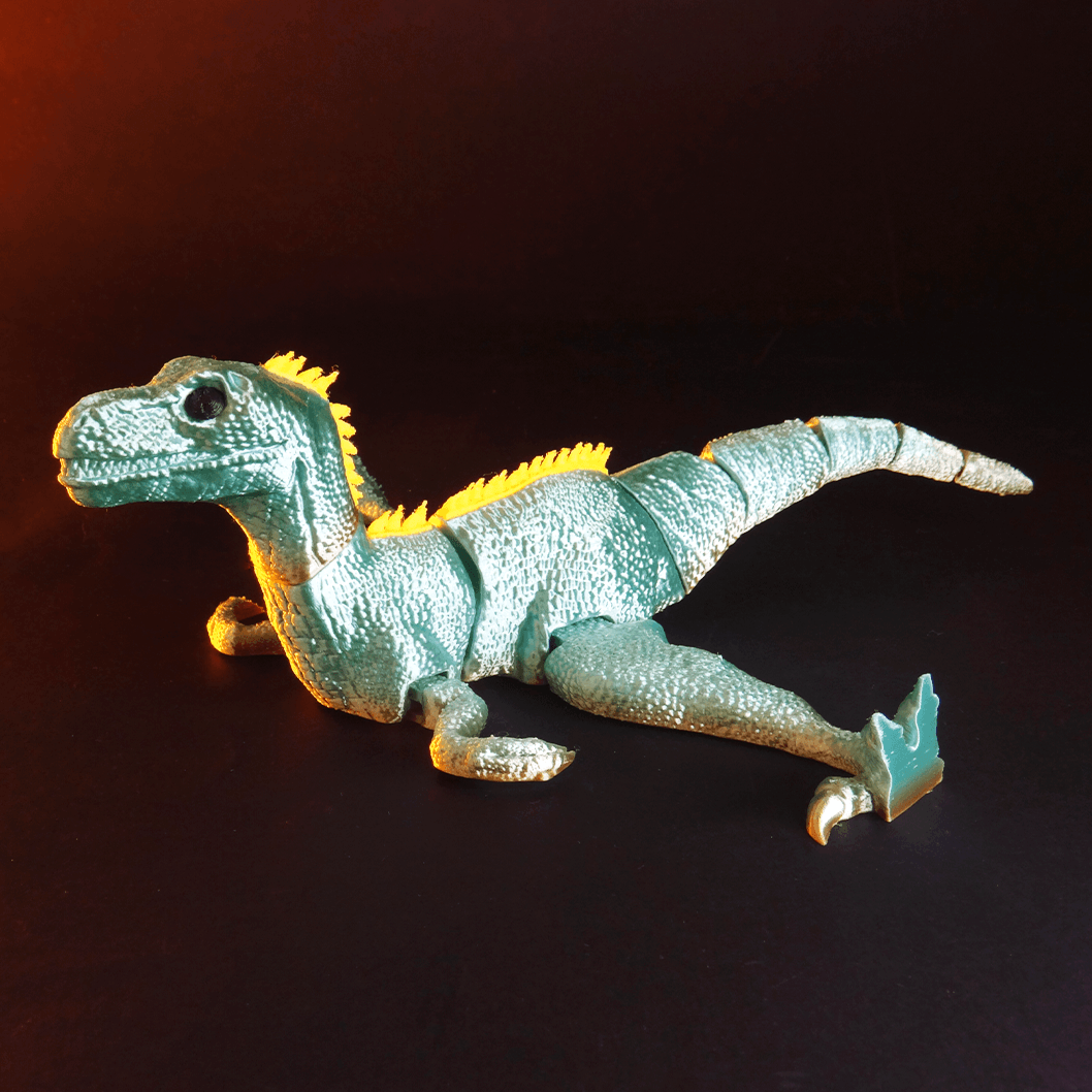 Heady Prints 3D printed teal articulated velociraptor figurine, angled view
