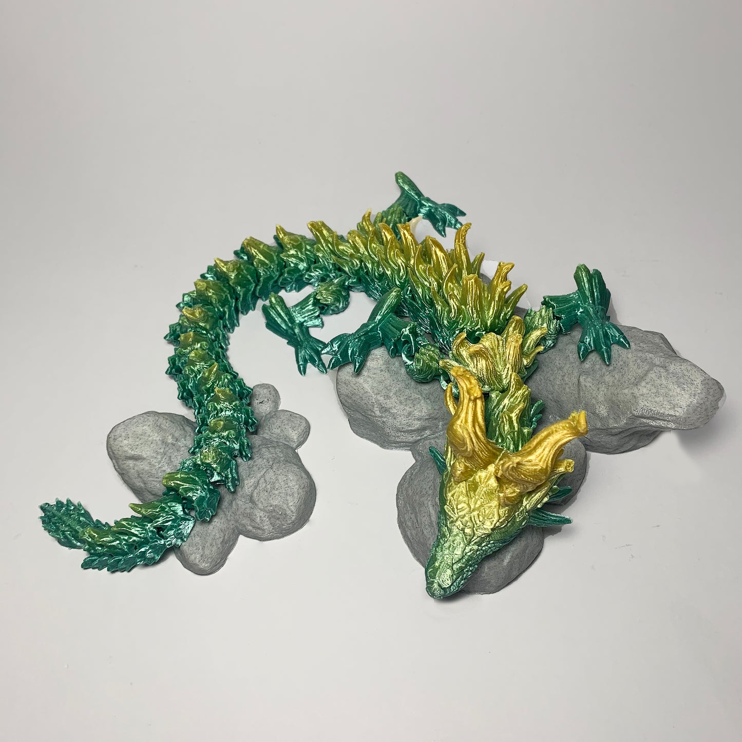 Heady Prints 3D printed Zandhros teal and yellow dragon figurine, outdoor angled view
